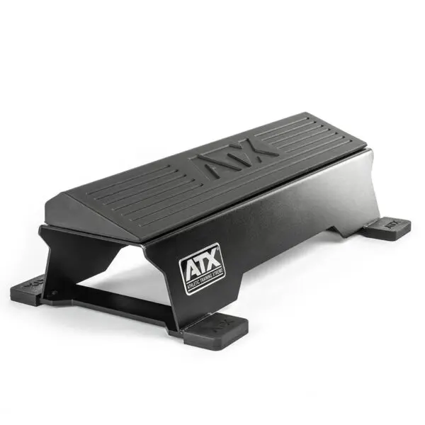 The ATX® Calf Block is a black, steel workout step featuring a non-slip surface and side logo, ideal for fitness exercises. This sturdy rectangular platform doubles as a calf block with a strong base and protective corner caps.