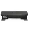 The ATX® Calf Block is a black athletic training step with a grooved surface and small rectangular feet, ideal for fitness routines. The ATX logo is on the side and top. It doubles as a calf block, perfect for targeted exercises and enhanced workouts.