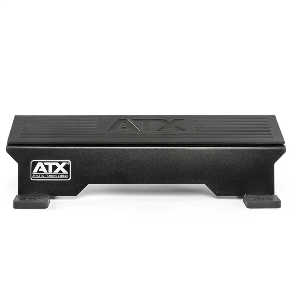 The ATX® Calf Block is a black athletic training step with a grooved surface and small rectangular feet, ideal for fitness routines. The ATX logo is on the side and top. It doubles as a calf block, perfect for targeted exercises and enhanced workouts.