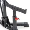 Close-up of the ATX® Competition Combo Rack, a sturdy black metal squat rack with a sleek design and red safety pin. It features multiple height adjustment holes and ATX labeling.