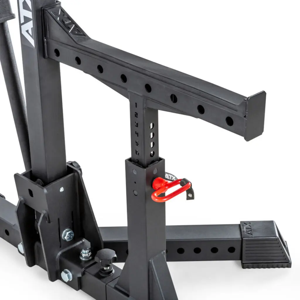 Close-up of the ATX® Competition Combo Rack, a sturdy black metal squat rack with a sleek design and red safety pin. It features multiple height adjustment holes and ATX labeling.