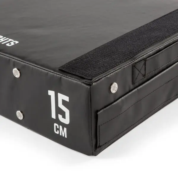 Close-up of an ATX® 15 cm Soft Drop Block in black, displaying a corner with reinforced stitching and a 15 CM white print. The durable, textured surface features metal grommets and Velcro edging.