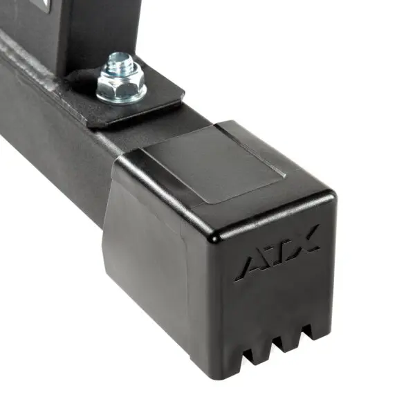 Close-up of a black ATX bar attachment, featuring a notched square end cap, secured with a metallic bolt. Engraved with ATX, its perfect for the ATX® Flat Bench Compact. The surface is smooth and matte.