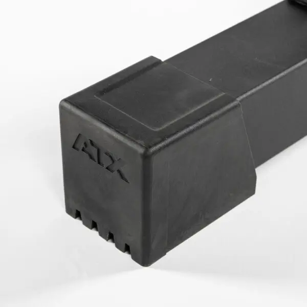 A black, rectangular ATX® Flat Bench PRO with grooves on one end and ATX embossed on the side is placed on a white surface.