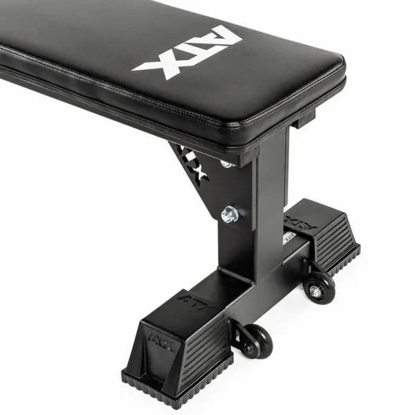 The ATX® Flat Bench is a black weight lifting bench with ATX branding, sturdy metal legs, and two wheels for easy mobility. Ideal for home or gym use, this sleek, modern bench ensures stability and convenience during workouts.
