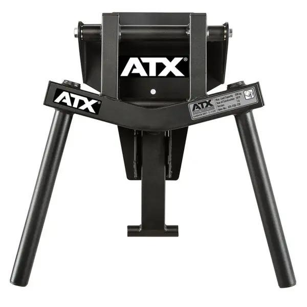 The ATX® Folding Wall Mounted Dip Handles have a black, sturdy metal frame with two angled legs and folding arms. They are designed for use with exercise equipment and feature a logo on top and a specifications label.