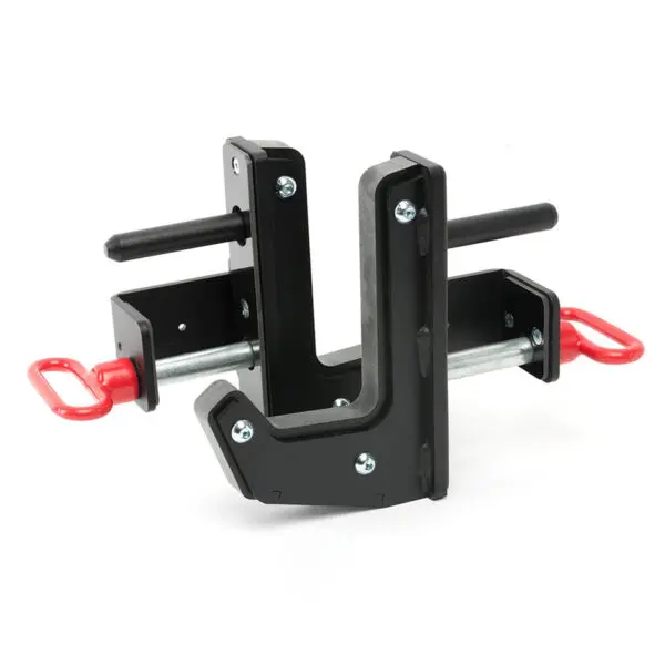 Close-up of ATX® J-Hooks Type III with black metal, red handles, and a robust design. Ideal for gym equipment like squat racks, featuring bolts and an interior lining to securely hold weightlifting bars.