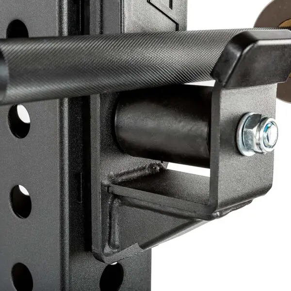A close-up of an ATX® Roller J-Hooks shows its cylindrical design with a bolt on the side, resting on a weight rack. The black metal J-cup allows for adjustable height placement via multiple rack holes.