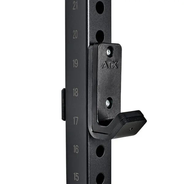 Close-up of the ATX® Wall Mounted Squat Rack in black metal, featuring numbered adjustment holes and a J-hook for weightlifting bars. This rack is sturdy and ideal for gym use.