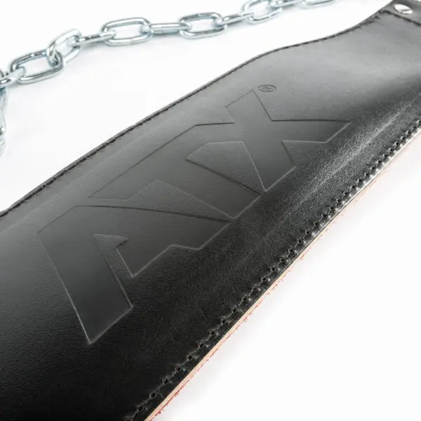 Close-up of the ATX® Leather Dip Belt, a black leather belt featuring ATX embossing. Its attached to a metal chain, perfect for enhancing your weightlifting routine.