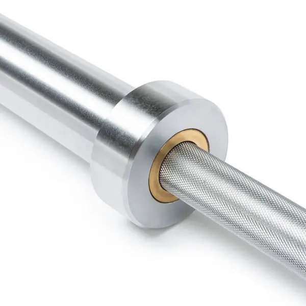 Close-up of the ATX® Olympic Power Barbell with Centre Knurling, highlighting its shiny silver finish, textured grip, and smooth metal sleeves. The barbell is partially visible, showing detailed knurling and sleeve connection.