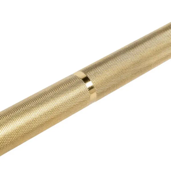 Close-up of the ATX® Olympic Golden Powerlifting Bar, featuring a gold-colored, textured metal design with a smooth, shiny band in the center. Its intricately patterned surface enhances grip, resembling weightlifting equipment against a plain white background.