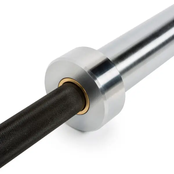 Close-up of the ATX® Olympic Power Barbell - Black featuring a smooth silver sleeve and black textured grip on the bar. A golden ring marks where the bar connects, enhancing its design.