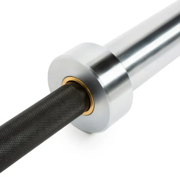 Close-up of The Original ATX® Ram Olympic Power Bar sleeve. The image highlights a textured black bar linked to a smooth, metallic silver sleeve with brass ring detail, set against a plain white background, showcasing its sleek design.
