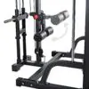 Close-up of the ATX® Smith Machine System Plate Loaded, showcasing padded rollers, a black metal frame, and an adjustable lever with a red knob. An arrow indicates movement direction with the floor visible beneath.
