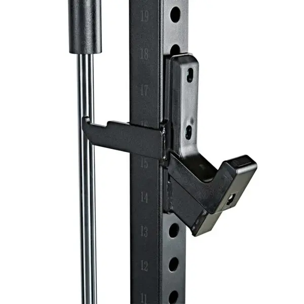 Close-up of the ATX® Smith Machine System Plate Loaded shows an adjustable weight rack with a black metal support arm, marked from 13 to 19. The arm connects to a vertical section with adjustment holes.