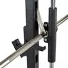Close-up of the ATX® Smith Machine System Plate Loaded, featuring a barbell with safety catches and knurled grip, resting on a rack with measurement markers for weightlifting or gym use.
