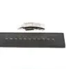 A black leather strap with evenly spaced holes is laid out horizontally, above which sits a modern silver metal clasp labeled ATX®. The clasp is detached from the strap.