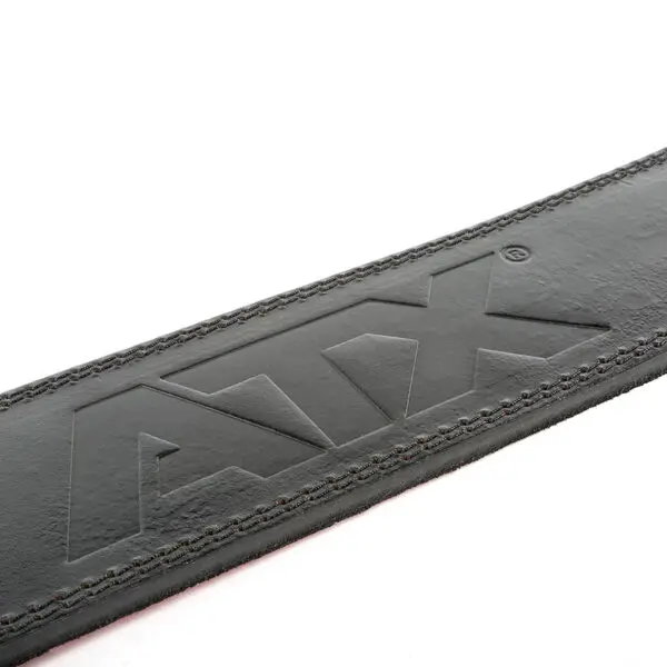 Close-up of the ATX® Lever Leather Powerlifting Belt in black leather, embossed with the letters ATX. The belt showcases detailed stitching along the edges against a plain white background.