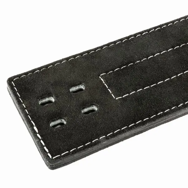 Close-up of the ATX® Lever Suede Power Belt in black suede, featuring four small holes and white stitching along the edge. The belt is partially shown, focusing on the end with the holes.