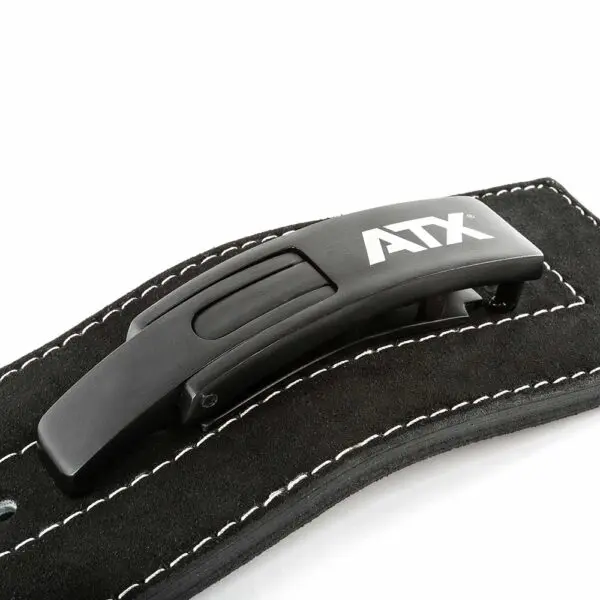 Close-up of a black buckle attached to the ATX® Lever Suede Power Belt, featuring a sleek, modern design with a matte finish on the black leather strap adorned with white stitching, all set against a white background.