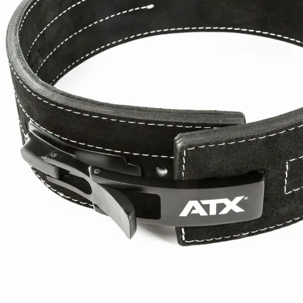 A detailed view of the ATX® Lever Suede Power Belt showcases its sleek black design with white stitching and a prominent lever buckle. The belt displays the ATX logo in white, with both the buckle and stitching standing out against a simple background.
