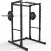 The ATX® Power Rack 610 195cm for Low Ceilings is a black squat rack ideal for low spaces, featuring a barbell with branded weights, adjustable holes for multiple lifting heights, and a sturdy pull-up bar.