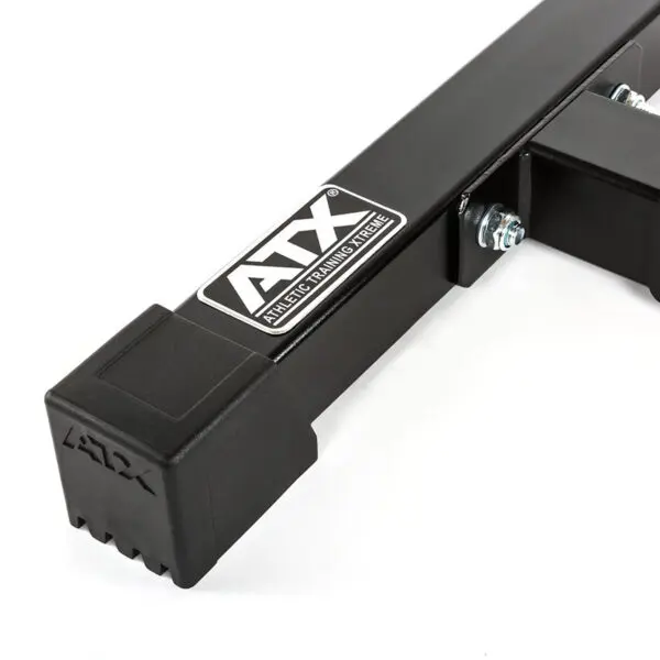 Close-up of a black metal fitness equipment part from the ATX® Landmine Barbell Stand, featuring the logo ATX and text Athletic Training Xtreme. The part has bolts and a square rubber end cap with textured detailing.