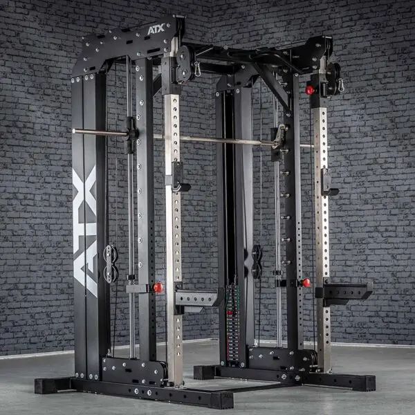 A large, black ATX® Smith Cable Rack Weight Stack featuring a pulley system, adjustable safety bars, and a pull-up bar is set against a gray brick wall in a gym setting.