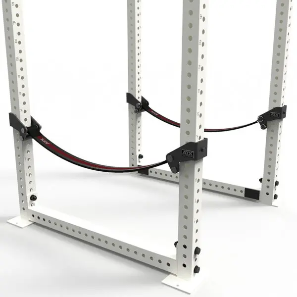 The ATX® Safety Strap 800 is a white metal squat rack with adjustable black and red safety straps, featuring multiple holes for custom adjustments, set against a plain white background.