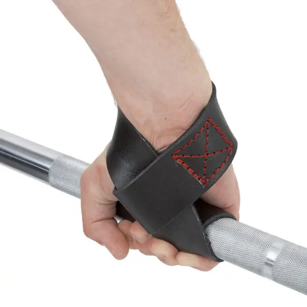 A hand grips a silver barbell, encased in a black leather lifting strap with red stitching, reminiscent of the ATX® Bulls Strongman Yoke.