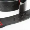Close-up of a slightly curved black ATX® Bulls Strongman Yoke DISCONTINUED strap with red stitching and an embossed ATX logo on a white background.