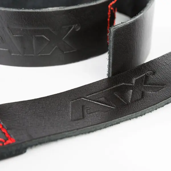 Close-up of a slightly curved black ATX® Bulls Strongman Yoke DISCONTINUED strap with red stitching and an embossed ATX logo on a white background.