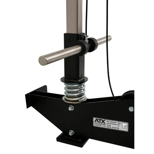 Close-up of the ATX® Wall Mounted Lat Pulldown's adjustable components, showcasing a metal handlebar and spring mechanism. The ATX brand label is clearly visible, highlighting the machine's maximum load capacity of 110 kg (242 lbs).