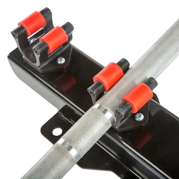 Close-up of the Barbell Cue Rack - Wall Mounted, featuring a textured metal bar secured by red and black rollers on a sturdy black mount attached to a flat surface with visible screws.