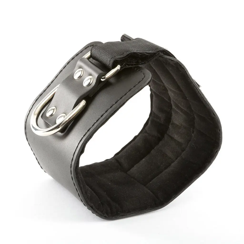 A black PU leather Cable Machine Ankle Cuff with a metal buckle and D-ring rests on a white background. It looks sturdy and adjustable, ideal for restraint or accessory purposes.