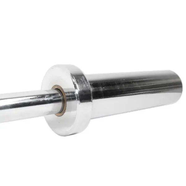 A close-up of the Power Maxx 4ft Olympic Barbell sleeve shows its shiny metallic surface reflecting light, with a circular groove at the inner end for weightlifting plates, emphasizing its polished finish.