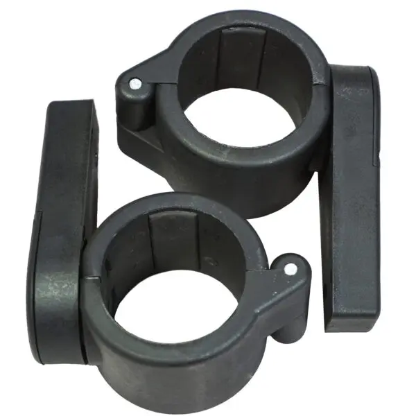 Two Power Maxx Olympic Bar Clamps, black plastic with circular openings, secures pipes or rods. Each clamp has a hinged latch for easy fastening and release. The clamps sit side by side on a white background.