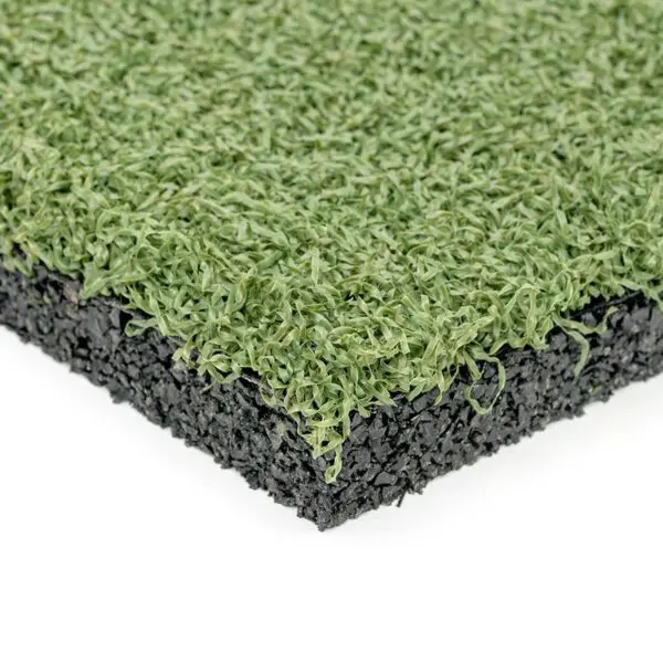 Close-up view of a cross-section of GymFloor® RTS Turf 50x50@20mm. The top layer features green synthetic grass blades, with a compact black crumb rubber or foam middle layer for cushioning, neatly highlighting its structure.