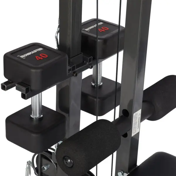 The Ironmaster Cable Tower Attachment V2 features adjustable weights, cushioned handles, and visible weight indicators set at 40. Its black and silver components highlight a durable, compact design ideal for home gyms.