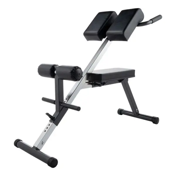 The Ironmaster Cable Tower Seat is black and silver, featuring padded supports for legs and hips. It has adjustable settings for various user heights, an angled frame, and a non-slip base. Designed for back and core exercises with ergonomic use in mind.