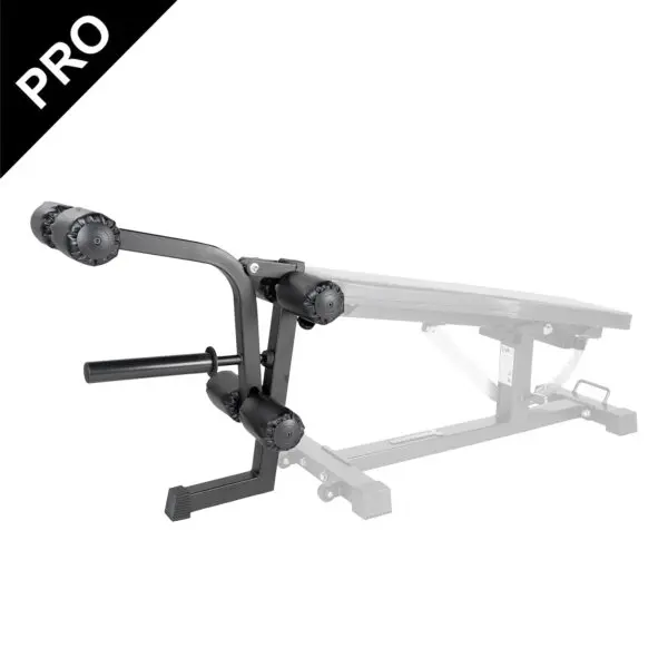 The Ironmaster Leg Lift PRO, featuring roller pads, is attached to a transparent gym bench for leg exercises and muscle training. A PRO label is visible in the top left corner.
