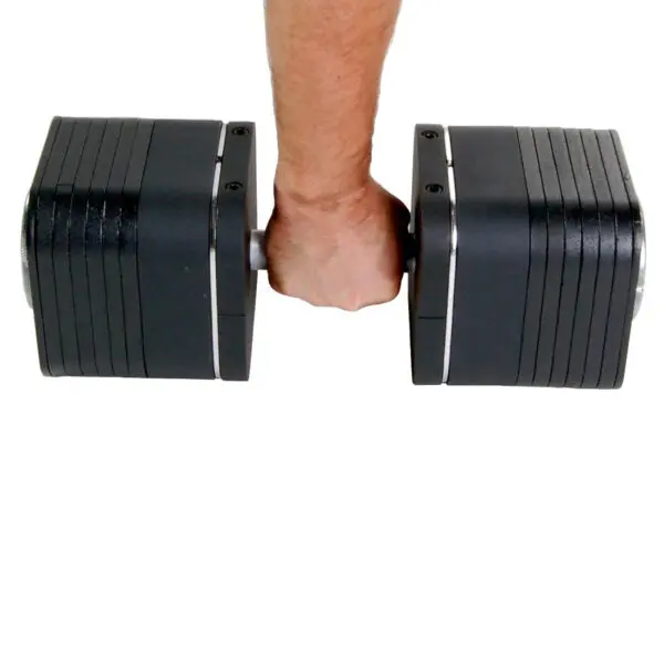 A person holds an Ironmaster Heavy Handle Kit, featuring a large black adjustable dumbbell with several weight plates attached. The white background accentuates the dumbbells impressive size and sleek design.