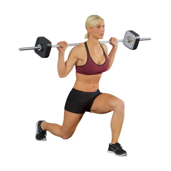 A person executing a lunge with the Ironmaster Straight Barbell on their shoulders. They wear a maroon sports bra, black shorts, and black and white athletic shoes against a white background, highlighting the subject.