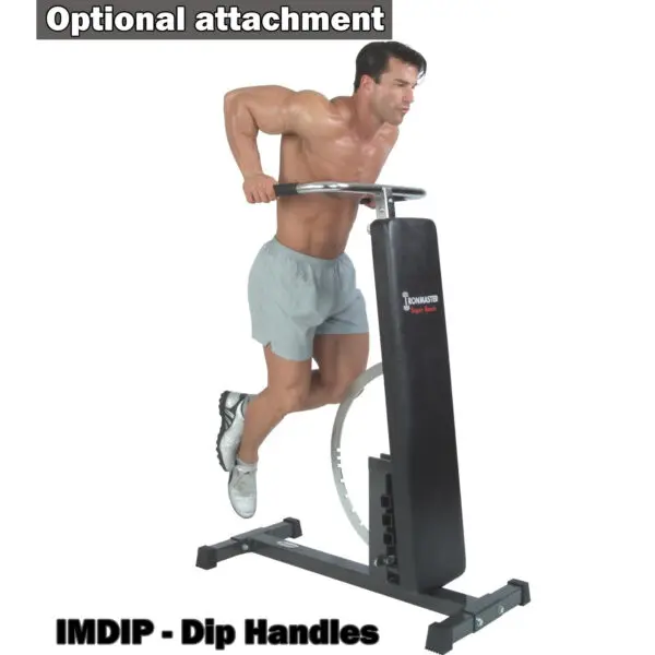 A person uses the IMDIP - Dip Handles, part of the Ironmaster Super Weights Bench, for a dip exercise. They are dressed in shorts and athletic shoes.