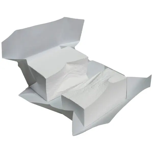 An open package reveals two white, rectangular blocks of soft substance, resembling gym chalk, resting on crumpled white wrapping paper.