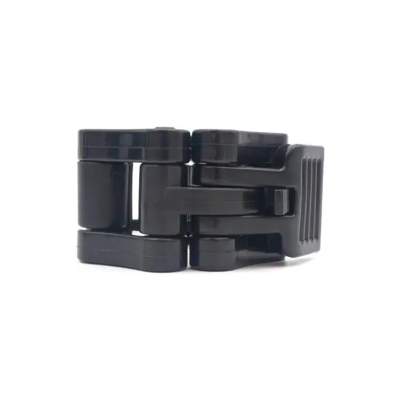 A black folding buckle closure on a white background with interlocking rectangular components and a ribbed side, similar to Olympic Lock Jaw Collars.