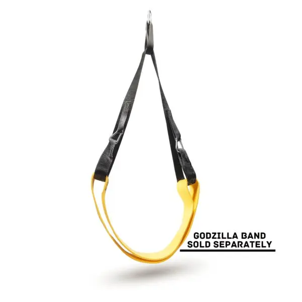 A yellow and black looped exercise band, Spud Inc The Big Ray Strap, is suspended against a white background. Text reads, Godzilla Band Sold Separately.