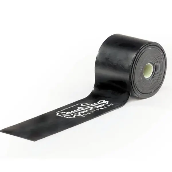 A black roll of Spud Inc Elephant Band with Stop A Flat in white is partially unrolled, showcasing a smooth texture and sturdy look, engineered to prevent punctures.