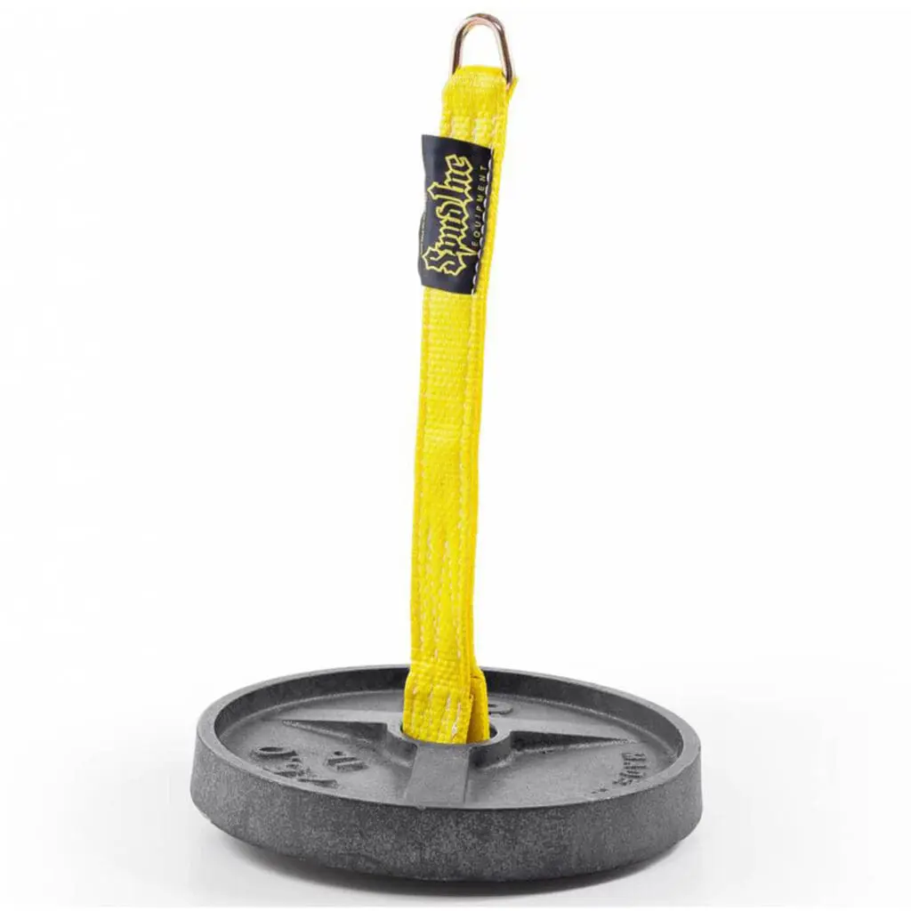 The Spud Strap Loading Pin 18 features a round metal base with a vertical yellow fabric strap. A reinforced loop at the top is secured by a metal ring and the strap displays a black label with yellow text.